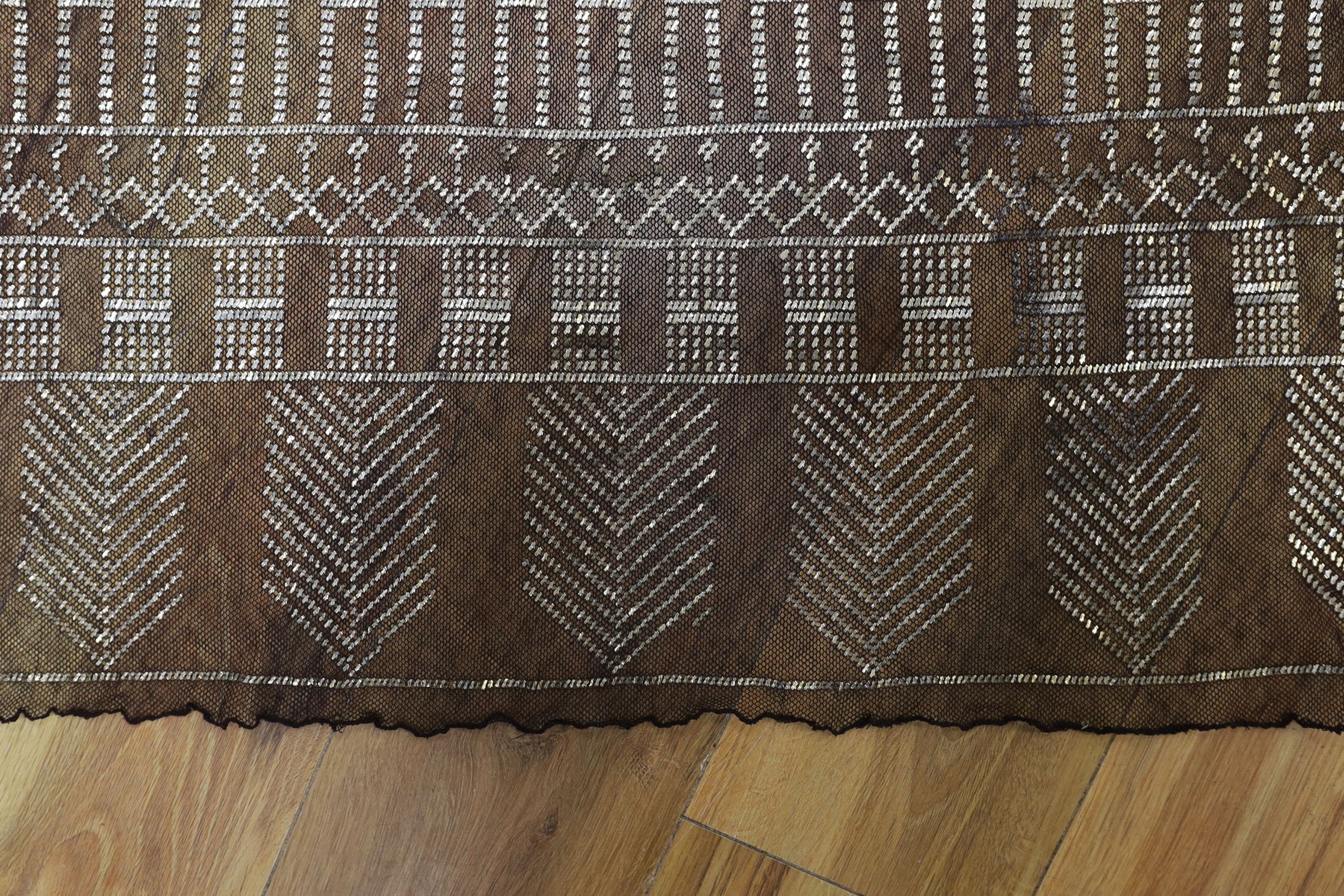 A dress made from a metal and black net Egyptian shawl; a similar shawl and a piece of shawl